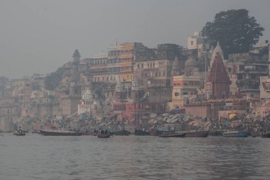 VARANASI, INDIA - DECEMBER 20: Hindus perform ritual puja at dawn in the Ganges River on December 20, 2007 in Varanasi, India
