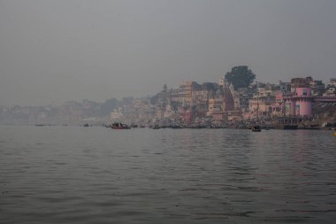 VARANASI, INDIA - DECEMBER 20: Hindus perform ritual puja at dawn in the Ganges River on December 20, 2007 in Varanasi, India