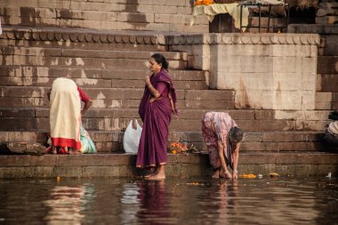 VARANASI, INDIA - NOVEMBER 15: Hindu pilgrims take a holy bath in the river ganges on November 15, 2013 in Varanasi, Uttar Pradesh, India 