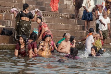VARANASI, INDIA - NOVEMBER 15: Hindu pilgrims take a holy bath in the river ganges on November 15, 2013 in Varanasi, Uttar Pradesh, India 
