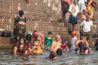 VARANASI, INDIA - NOVEMBER 15: Hindu pilgrims take a holy bath in the river ganges on November 15, 2013 in Varanasi, Uttar Pradesh, India 