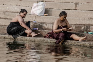 VARANASI, INDIA - NOVEMBER 15: Hindu pilgrims take a holy bath in the river ganges on November 15, 2013 in Varanasi, Uttar Pradesh, India 