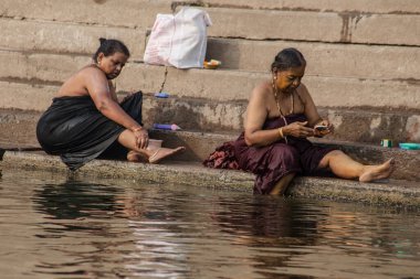 VARANASI, INDIA - NOVEMBER 15: Hindu pilgrims take a holy bath in the river ganges on November 15, 2013 in Varanasi, Uttar Pradesh, India 