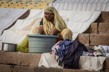 VARANASI - NOVEMBER 22: Unidentified hindu women on the sacred Ganges river banks at Dashashwamedh ghat on November 22, 2012 in Varanasi, State of Uttar Pradesh, India 