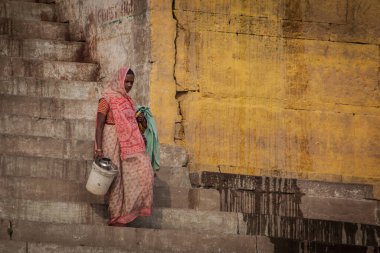 VARANASI - NOVEMBER 22: Unidentified hindu women on the sacred Ganges river banks at Dashashwamedh ghat on November 22, 2012 in Varanasi, State of Uttar Pradesh, India 