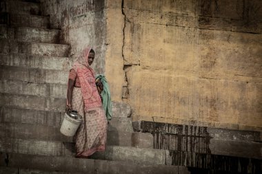 VARANASI - NOVEMBER 22: Unidentified hindu women on the sacred Ganges river banks at Dashashwamedh ghat on November 22, 2012 in Varanasi, State of Uttar Pradesh, India 
