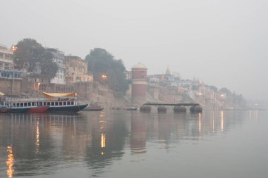 VARANASI, INDIA - DECEMBER 20: Hindus perform ritual puja at dawn in the Ganges River on December 20, 2007 in Varanasi, India