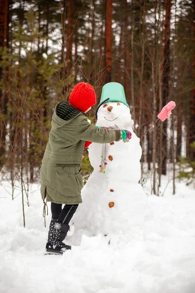 Girl Green Coat Winter Forest Snowman — стоковое фото