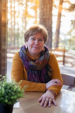 Joyful old lady enjoying coffee at outdoor cafe stock photo