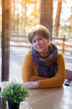 Joyful old lady enjoying coffee at outdoor cafe stock photo