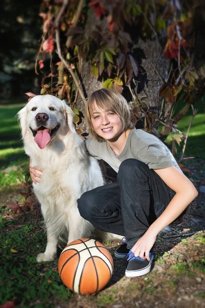 Boy with his dog in the park — Stock Photo, Image