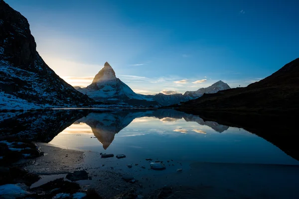 Matterhorn and Dente Blanche from Riffelsee mountain lake above