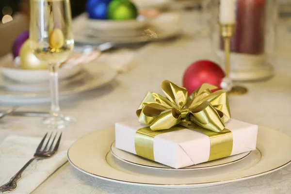 Gold ribbon gift on table — Stock Photo, Image