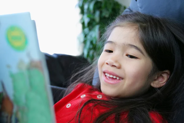 Child happily reading a book — Stock Photo, Image