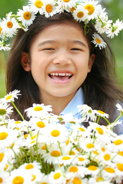 Beautiful little girl with crown of daisies — Stock Photo, Image