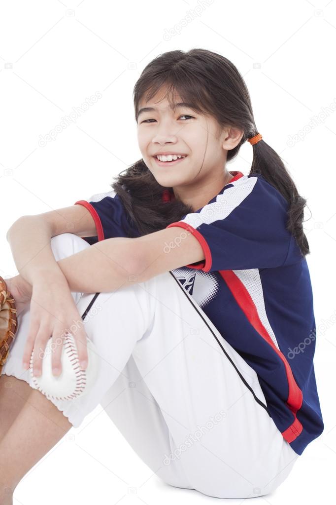 Little league softball player holding ball