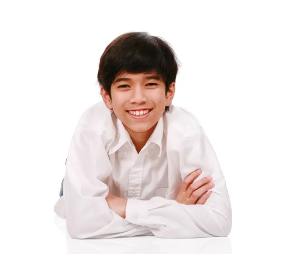 Handsome biracial teen boy smiling, lying down — Stock Photo, Image