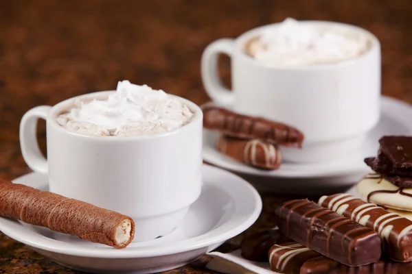 Two cups of coffee or hot cocoa with chocolates and cookies on — Stock Photo, Image