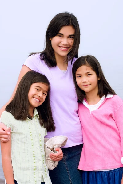 Three sisters together on foggy beach — Stock Photo, Image