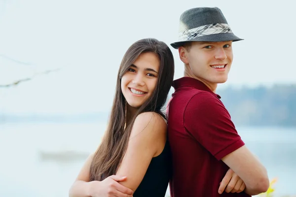 Schönes junges interrassisches Paar, das Rücken an Rücken steht — Stockfoto