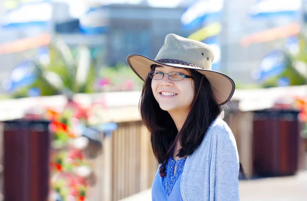 Young Teen Girl Smiling Outdoors Wearing Hat Sunny Colorful Background — 图库照片