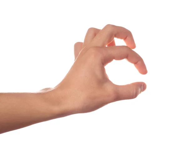 Mão humana segurando algo no fundo branco — Fotografia de Stock