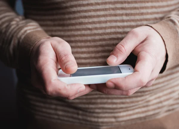 The man uses a tablet PC. Modern gadget in hand. — Stock Photo, Image