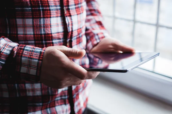 The man uses a tablet PC. Modern gadget in hand. — Stock Photo, Image