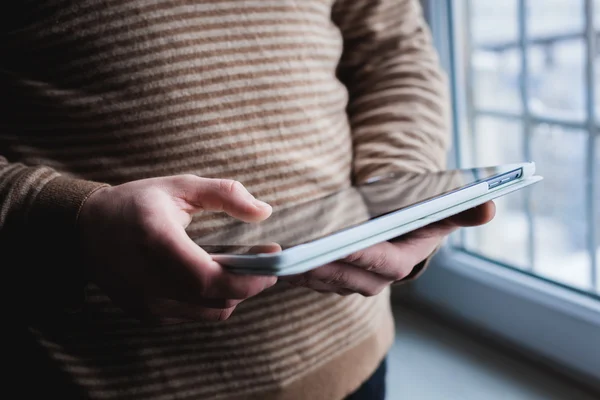 De man gebruikt een tablet PC. Moderne gadget in de hand. — Stockfoto