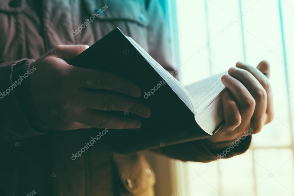 Man reading. Book in his hands.