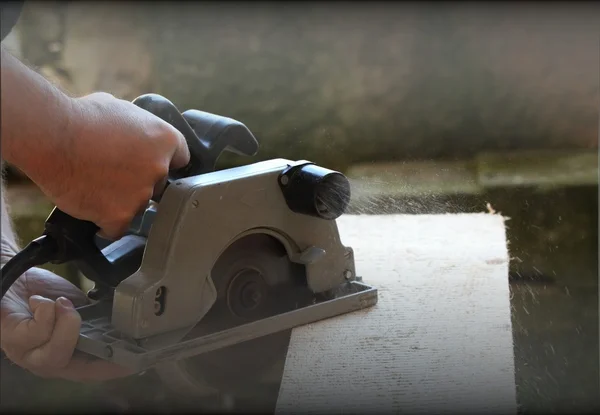 Wood cutting with handheld saw, filtered — Stock Photo, Image