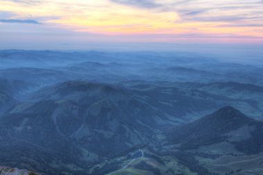 Sunset over rolling hills, Switzerland clipart