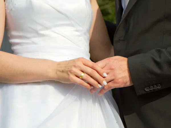 Жених и невеста держатся за руки после свадьбы — стоковое фото