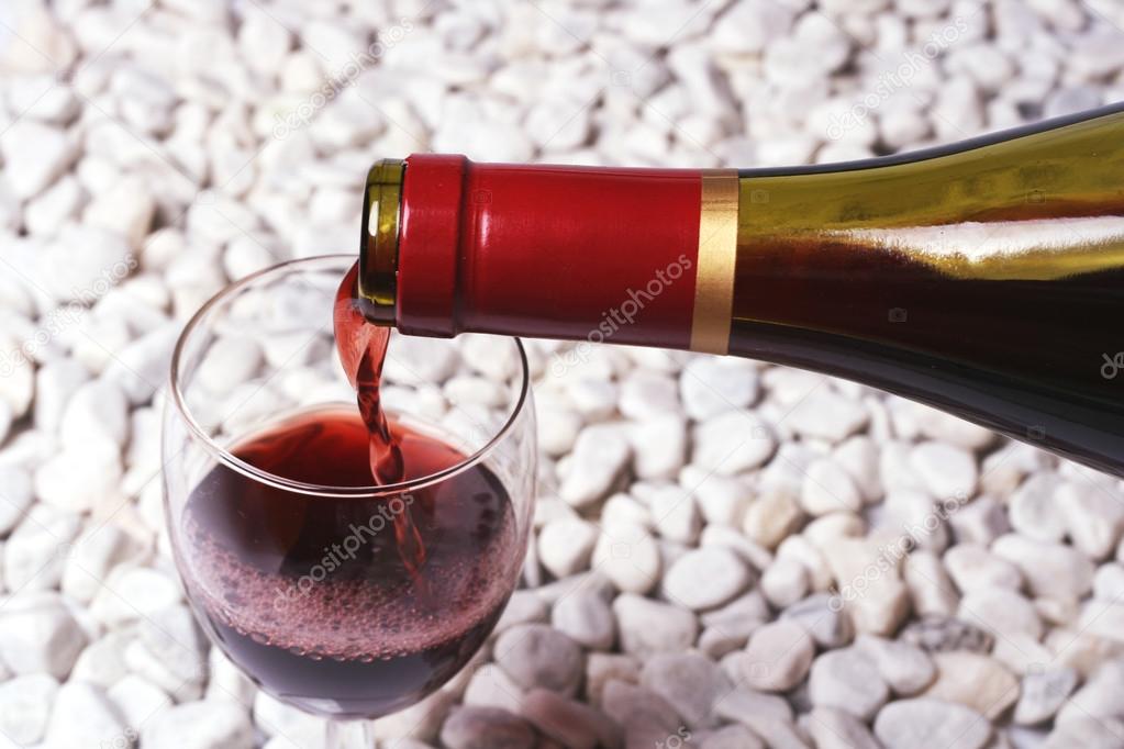 Red wine on the white stone.