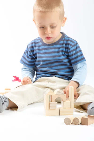 Petit garçon mignon jouant avec les blocs de construction. Isolé sur blanc . — Photo