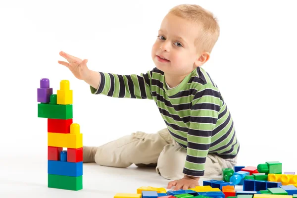 Little cute boy playing with building blocks. Isolated on white. — Stock Photo, Image