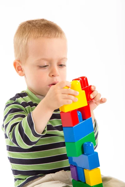 Little cute boy playing with building blocks. Isolated on white. — Stock Photo, Image