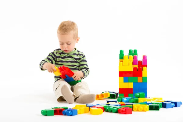 Menino bonito brincando com blocos de construção. Isolado em branco . — Fotografia de Stock