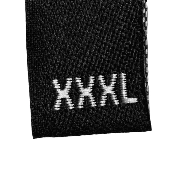 XXXL boyutu giyim etiketi etiket, siyah kumaş, izole macrp tatlı — Stok fotoğraf