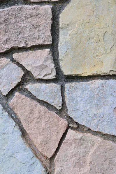 Stone fence background, vertical stonewall closeup, decorative limestone slate slab rock