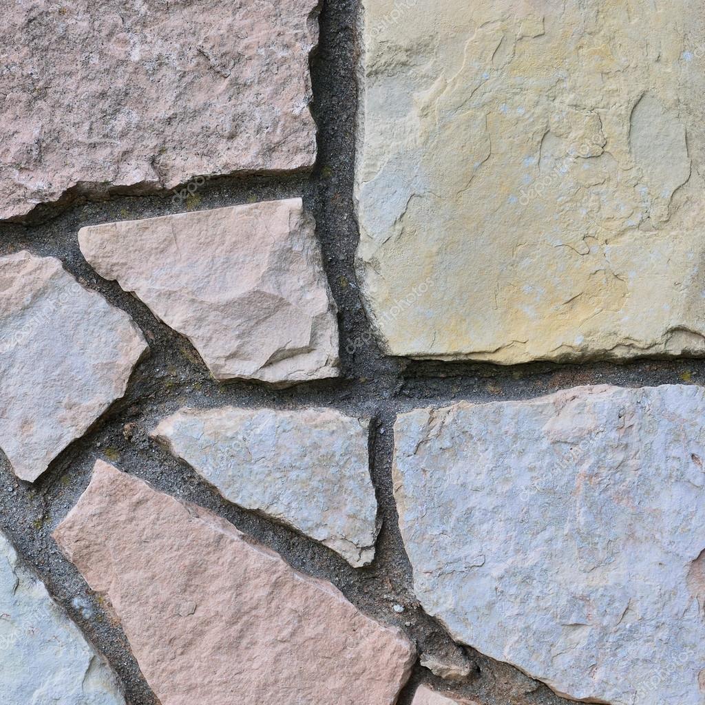 Stone fence background, vertical stonewall closeup, decorative