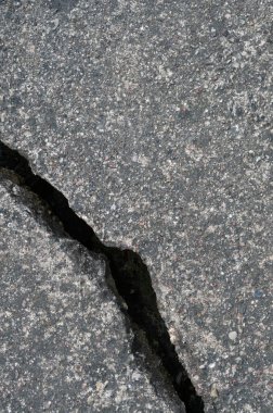 Old aged weathered cracked grey black tarmac texture pattern, large detailed damaged textured asphalt grungy background flat lay, vertical rough grained broken pattern macro closeup grunge copy space