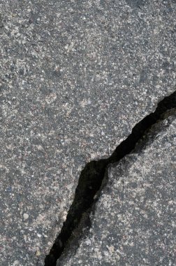 Old aged weathered cracked grey black tarmac texture pattern, large detailed damaged textured asphalt grungy background flat lay, vertical rough grained broken pattern macro closeup grunge copy space