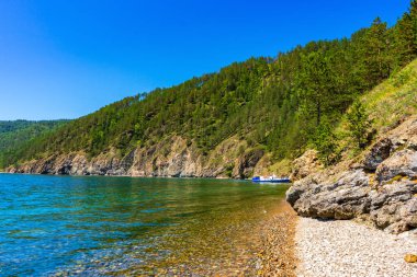Great Baikal Trail. Popular route along lake Baikal shore from Listvyanka to Big Koty. Lake Baikal coast, hill with forest, water bay. Summer travel, discovery of beauty of Earth. Siberia, Russia.