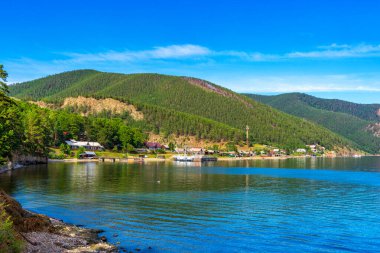 Great Baikal Trail. Popular route along lake Baikal shore from Listvyanka. View to Bolshie Koty village at lake Baikal coast, water bay. Summer travel, discovery of beauty of Earth. Siberia, Russia.