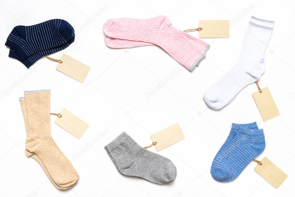 Various modern trendy women's cotton socks set with price tags on white background. Fashionable socks store. Socks shopping, sale, merchandise, advertisement concept. Flat lay, top view, copy space.