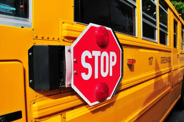 Stop sign on yellow school bus photographed in USA