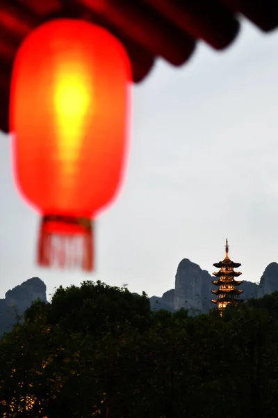 The foreground of traditional Chinese style lanterns, a photo of a traditional Chinese style tower