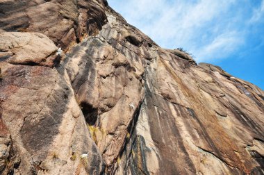 Photo of steep rock wall against blue sky background, China, Anhui Province, Mount Huang