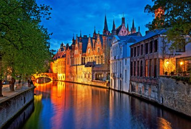 Medieval buildings along a canal in Bruges clipart